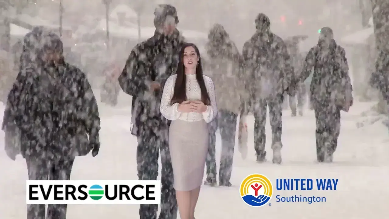 Frame from a TV commercial produced by Connecticut Website Company — an on-camera host in a snowy outdoor scene